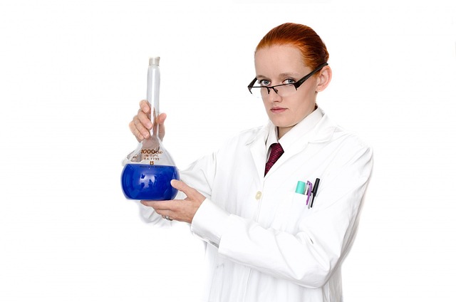 image showing Woman wearing lab coat in chemistry lab